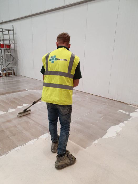 Applying a concrete sealer resin coat to a manufacturing and warehousing facility