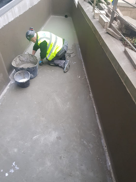 Applying Vandex BB75E polymer modified waterproofing cementitious coating to a hospital